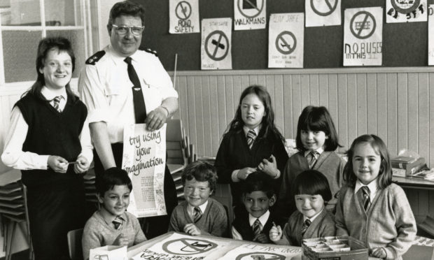 Pupils of Dens Road Primary, Dundee with Inspector Alistair Joss of Tayside Police with posters being designed by schoolchildren all over Scotland to promote road safety. Taken on May 24 1988.