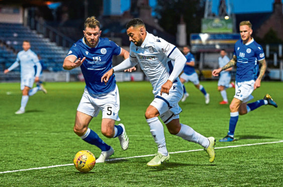 Queen of the South's Darren Brownlie, left. in action with Dundee's Kane Hemmings when the sides met in September.