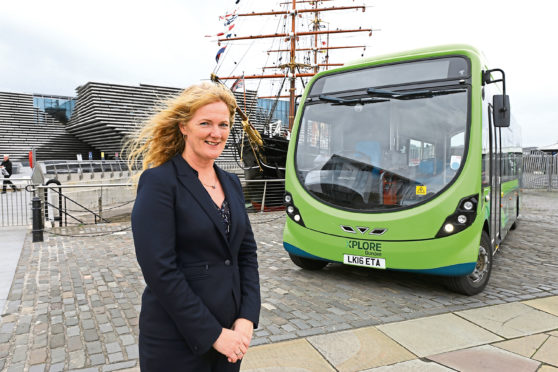Christine McGlasson - MD of Xplore Dundee beside one of the firm's buses.