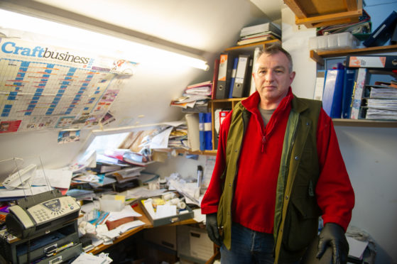 Mr Sturrock at his parents' ransacked shop in Letham, Angus.
