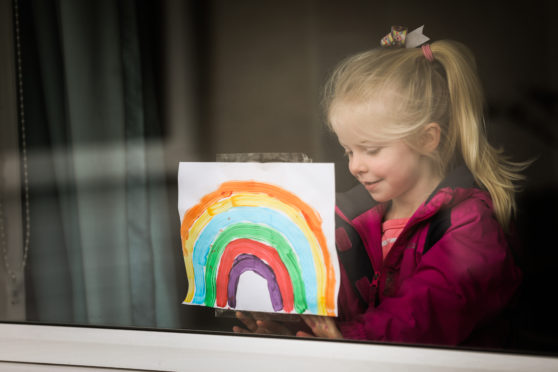 A delighted Poppy with one of her colourful creations.