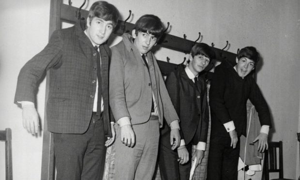 The Beatles hang out back stage at the Caird Hall.