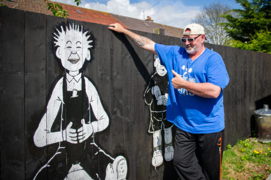 Jackie Handy with his mural.