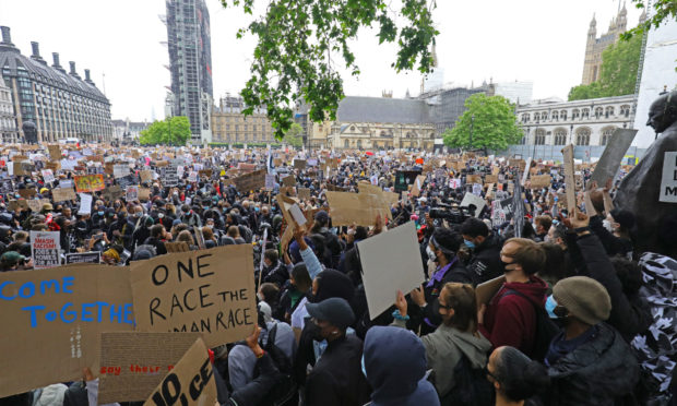 People take part in a Black Lives Matter protest rally in Parliament Square, London.