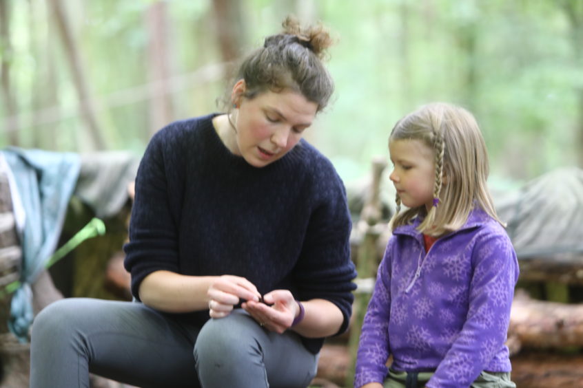 Sarah Latto - Manager chatting with one of the kids, at the Secret Garden Outdoor Nursery, near Letham in Fife.