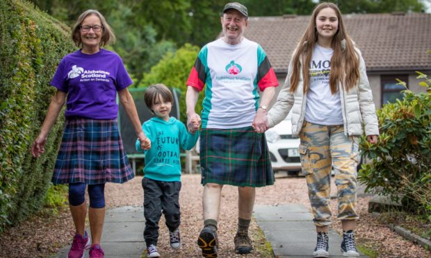 Derek and Patricia Stewart who will be taking part in the first virtual Kiltwalk are pictured with grandchildren Aaron Henderson, 4, and Farrah Henderson, 11.