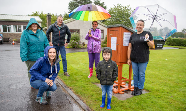 Back row from left: Sheona Chisholm, Rev Jonathan Humphrey, Melanie Jane Harrison and Glenda Watt. Front; Kate Humphrey and Cohenn Watt, at the community food box.