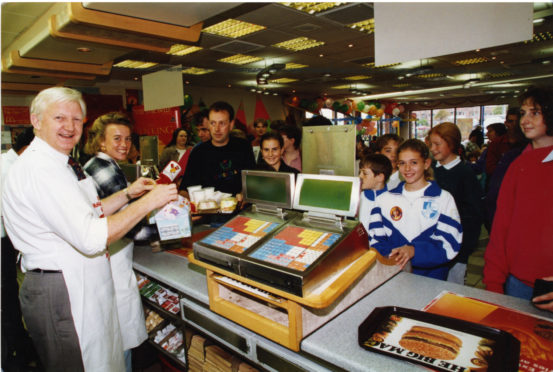 Liz McColgan and George Duffus at McDonalds for charity.