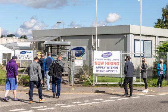 Workers returning to the factory on Monday.