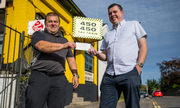 Charlie Duthie, left, and Simon Redmond with the cheque for the funds raised in their appeal to replace a stolen bicycle. Picture by Kim Cessford / DCT Media