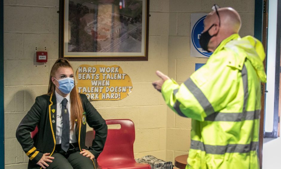 Rector Derek Allan speaks to pupils about wearing face coverings