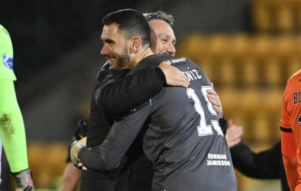 United manager Micky Mellon congratulates Deniz after shootout.