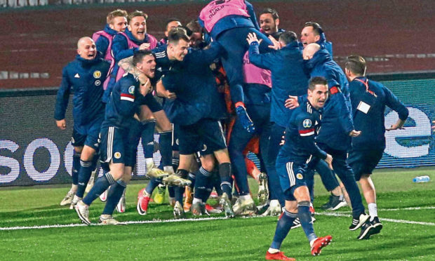 The Scotland team celebrate qualifying for their first major championships in 22 years.