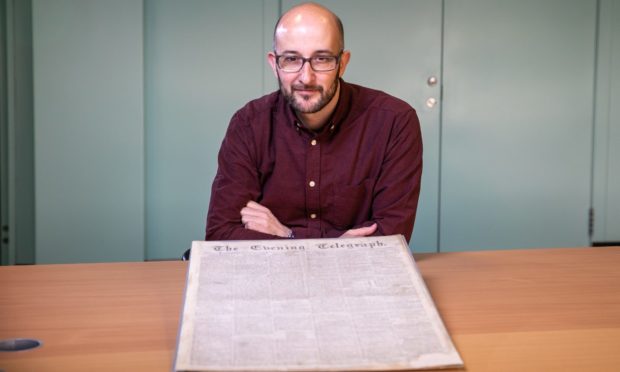 David Powell with the restored first edition of the Evening Telegraph. Photo by Kim Cessford/DCT Media.