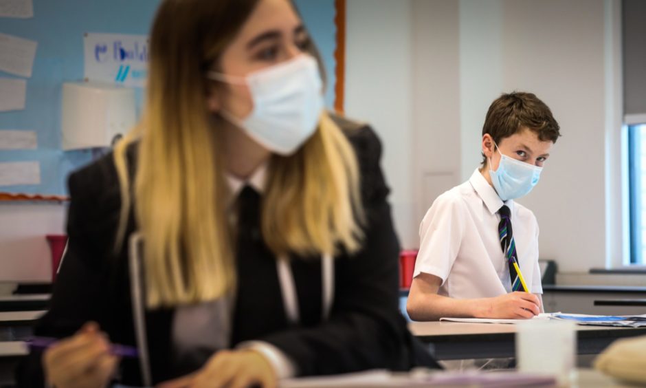 Pupils in chemistry lesson wearing their face masks.