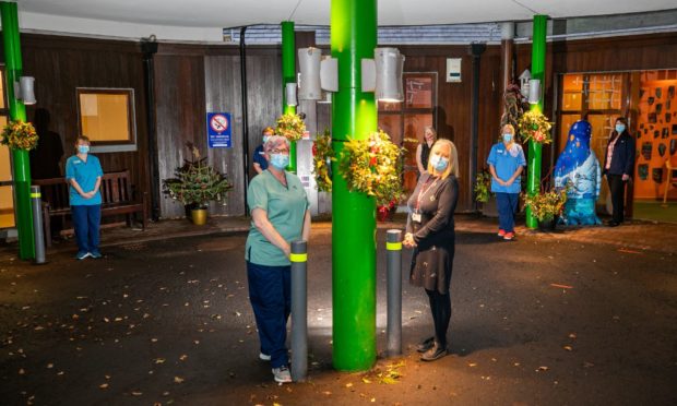 Some of the staff and volunteers with the seasonal decorations enhancing the entrance to Roxburghe House.
