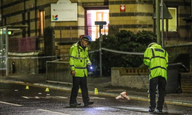 Police at the scene of the crash in Lochee.