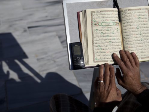 A Palestinian reads verses of the Koran during the month of Ramadan at Al Emari Mosque in Gaza City (Hatem Moussa/AP)