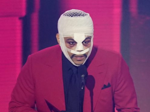 The Weeknd wore bandages wrapped around his face while accepting a price at the American Music Awards (Chris Pizzello/AP)