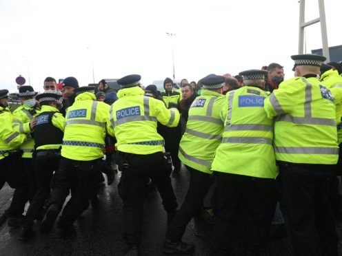 Police scuffle with lorry drivers outside the Port of Dover in Kent (Andrew Matthews/PA)