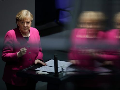 German Chancellor Angela Merkel addresses the German parliament Bundestag ahead of an European Union summit at the Reichstag building (Markus Schreiber/AP)