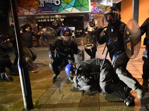 Police officers detain a man in Bristol (Ben Birchall/PA)