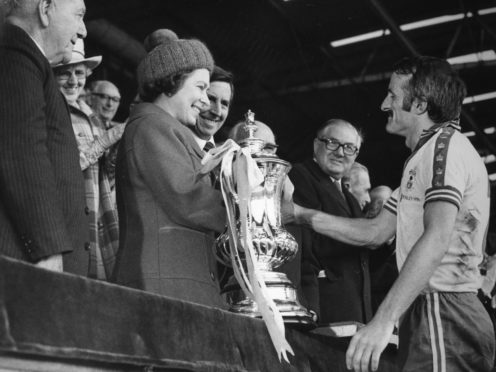 The Queen presents Southampton captain Peter Rodrigues with the FA Cup after the 1976 final at Wembley. (PA Archive/PA)