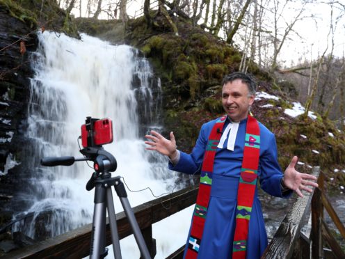 Rev Neil Glover, the minister at Aberfeldy Church in Perthshire, records a sermon beside the Birks of Aberfeldy waterfall (Andrew Milligan/PA)
