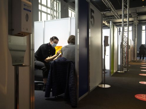 A man receives an injection of Covid-19 vaccine at the Science Museum in London (Victoria Jones/PA)
