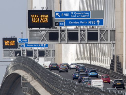 Traffic information signs read ‘Stay Local, Stay Safe, Save Lives’ above the M90 on the Queensferry Crossing near Edinburgh following the easing of Scotland’s lockdown restrictions to allow far greater freedom outdoors (Jane Barlow/PA)