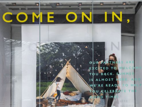 Undated handout photo issued by John Lewis of a staff members working on the shop windows at their White City store ahead of reopening on April 12.