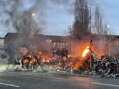 The wreckage of a Translink Metrobus on fire on the Shankill Road in Belfast (Liam McBurney/PA)