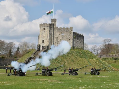 Members of the 104th Regiment Royal Artillery fire a gun salute in the grounds of Cardiff Castle (Ben Birchall/PA)