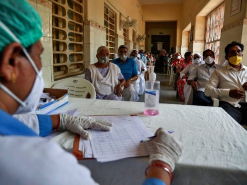 People wait for their turn to be administered Covishield vaccine at a government hospital in Hyderabad, India (Mahesh Kumar A/AP)
