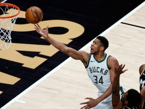 Milwaukee Bucks forward Giannis Antetokounmpo shoots in the first half of the NBA game against the Atlanta Hawks (John Bazemore/AP)