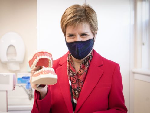First Minister Nicola Sturgeon has vowed that the SNP will abolish all NHS dentistry charges in Scotland (Jane Barlow/PA)