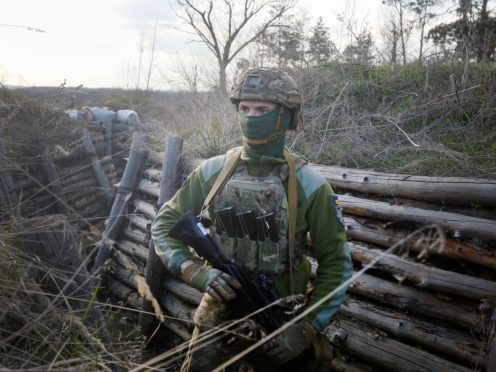 A Ukrainian soldier is seen at fighting positions on the line of separation from pro-Russian rebels near Luhansk, Ukraine, Friday, April 16, 2021. Growing cease-fire violations and a massive Russian military buildup near the Ukrainian border are causing tensions to rise in the conflict in eastern Ukraine, where more than 14,000 people have died in seven years of fighting between forces from Kyiv and separatists loyal to Moscow.(AP Photo/Efrem Lukatsky)