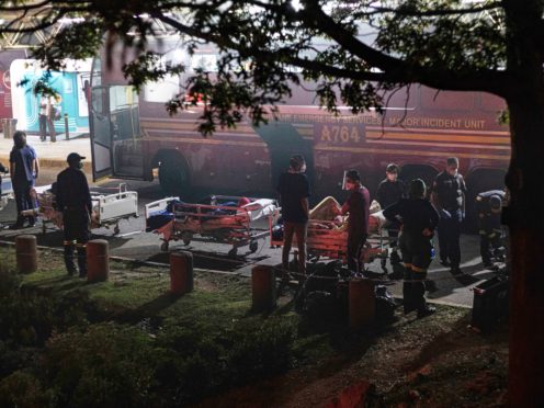 Hospital staff prepare to evacuate patients on stretchers (Ali Greef/AP)