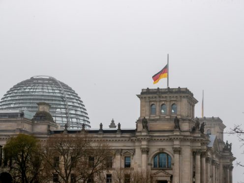 The German flag on top of the Reichstag building flies at half-mast (Christoph Soeder/dpa via AP)