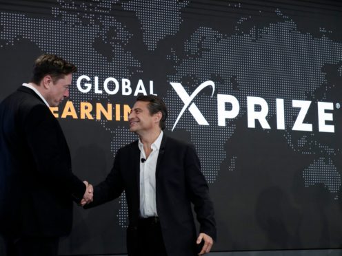 Elon Musk, left, shakes hands with XPRIZE founder and Executive Chairman Peter Diamandis during the presentation of the XPRIZE for Children’s Literacy in Los Angeles, in this Wednesday, May 15, 2019, file photo. Organizers of a $20 million contest to develop products from greenhouse gas that flows from power plants announced two winners Monday, April 19, 2021, ahead of launching a similar but much bigger competition backed by Elon Musk. Both winners made concrete that trapped carbon dioxide, keeping it out of the atmosphere, where it can contribute to climate change. Production of cement, concrete’s key ingredient, accounts for 7% of global emissions of the greenhouse gas, said Marcius Extavour, XPRIZE vice president of climate and energy.(AP Photo/Marcio Jose Sanchez, File)