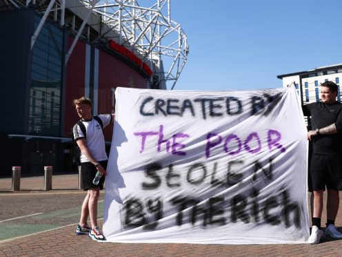 Football fans opposing the European Super League outside Old Trafford in Manchester (Tim Markland/PA)