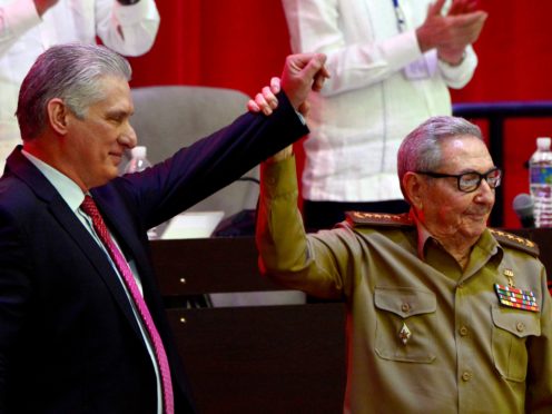 Raul Castro, right, raises the hand of Cuban President Miguel Diaz-Canel after he was elected First Secretary of the Communist Party at the closing session of Cuban Communist Party’s 8th Congress at the Convention Palace in Havana, Cuba (Ariel Ley Royero/ACN via AP)