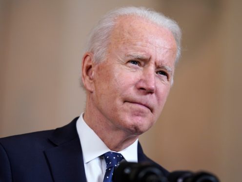 Joe Biden is announcing the updated US target at a summit he has convened (Evan Vucci/AP)