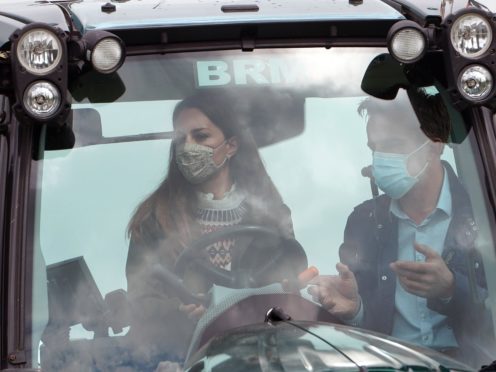 Farmer Stewart Chapman gives the Duchess of Cambridge instructions on how to drive a tractor during her visit to Manor Farm in Little Stainton, Durham (Owen Humphreys/PA)