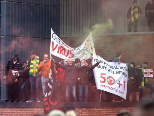 Fans holds up banners as they protest against the Glazer family at Old Trafford (Barrington Coombs/PA)