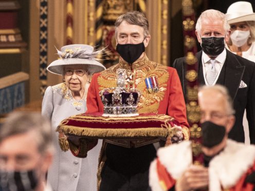 The Queen accompanied by the Prince of Wales, proceeds through the Royal Gallery (Richard Pohle/The Times/PA)