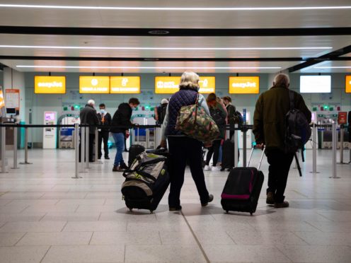 Passengers check in for the first holiday and leisure flight to take-off at Gatwick Airport (David Parry/PA)