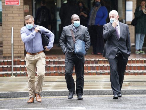 Metropolitan Police Pc Rudvelle Walters (centre) outside Southwark Crown Court, London (PA)