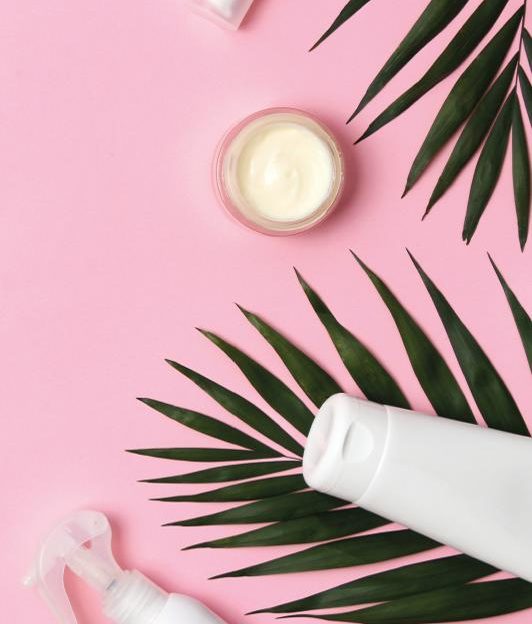 A pot of face cream on a pink background