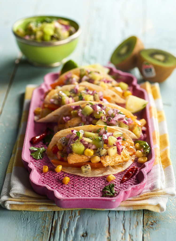 Zespri chicken and kiwi tacos laid out on a pink tray